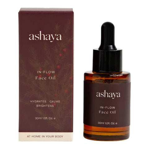 30ml dropper bottle of ashaya In-Flow Face Oil next to its box, a formula designed to support the skin during the menstrual years. This natural antioxidant botanical oil, infused with precious ingredients, helps reduce the first signs of aging, improve uneven skin tone, and soothe inflammation. Gently scented to calm and comfort you throughout your cycle. Suitable for all skin types.