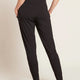 A model wearing black, lightweight lounge pants made of organic bamboo, featuring a draped fit with a wide waistband, tapered leg and two side pockets, showing the back.