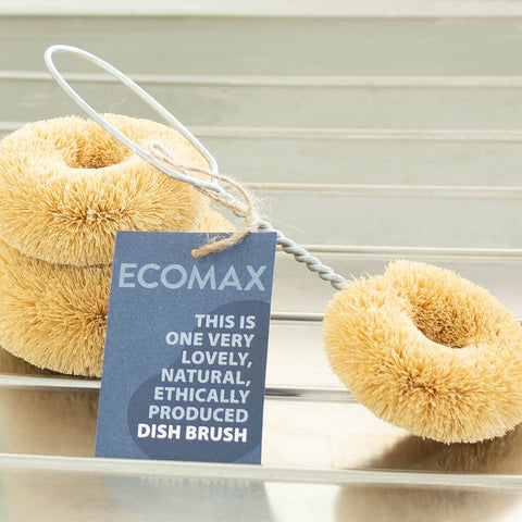 Plastic free, coconut fibre dish brush with a cardboard tag attached.