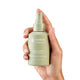 A hand gently holding a 120ml bottle of endota Signature Blend Room Spray. The hand is gently gripping the bottle, with a white background emphasising the product.