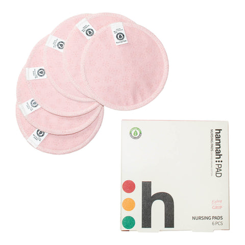 Box of hannahPAD reusable cloth Nusing Pads, a sustainable solution made of certified organic cotton to manage leaks, next to 6 pink nursing pads.