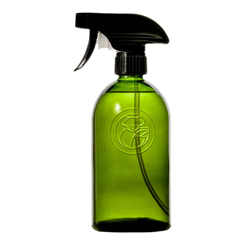 Green apothecary glass bottle with a spray trigger.