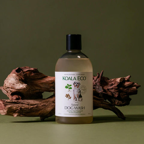 Plastic bottle of sweet marjoram and rosalina natural dog wash styled on a surface with decorative wood.