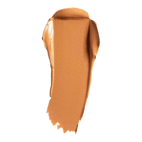 Swatch of cream foundation in the shade 'Bamboo', a deep tan shade with warm undertones.