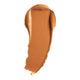 Swatch of cream foundation in the shade 'Challis', a deep tan shade with warm undertones.