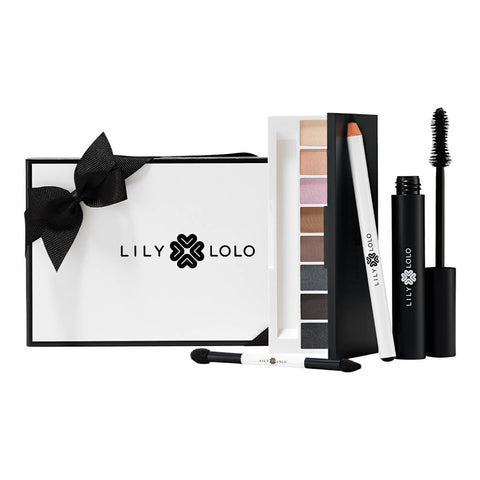 Lily Lolo Smokey Eye Collection makeup gift set including Smoke & Mirrors Eye Palette, black Natural Eye Pencil, and black Big Lash Mascara. Packaged in a black and white gift box with black ribbon.