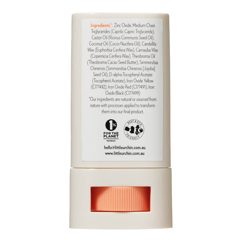 Back view of 20g tube of Natural Zinc Stick SPF 50+, a medium tint, hydrating, vegan formula that provides UVA and UVB broad spectrum protection from the sun while also being 4 hours water-resistant. The back shows the ingredients. Packaged in a cream tube with minimal orange and black text on the label.