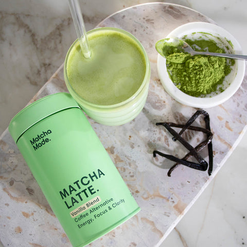 240g tin of Matcha Made Vanilla Matcha Latte styled with an iced matcha latte and vanilla beans. A coffee alternative flavoured with vanilla that promotes energy, focus, and clarity. Sustainably grown and harvested in Uji, Japan, and is certified organic and pesticide-free.