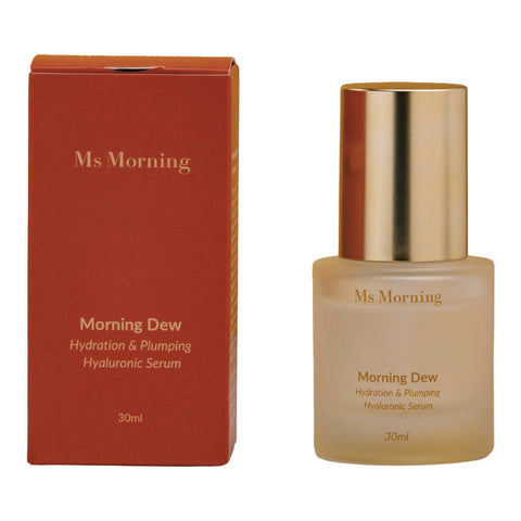 30ml bottle of Ms Morning Morning Dew Hydration Plumping & Hyaluronic Serum, a weightless serum that provides both instant and long-lasting hydration, next to its red box. Packaged in a frosted glass jar with a gold lid.