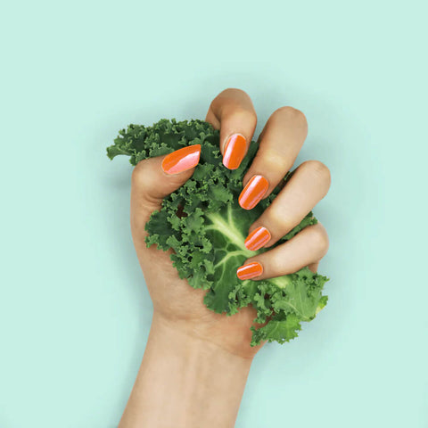 Nails painted with non-toxic, bright orange nail polish with kale protein infusion.