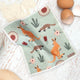 RetroKitchen Compostable Sponge Cloth, a super absorbent, machine washable and compostable dish cloth with a kangaroo design on a bench with a wooden spoon, flour, and eggs.