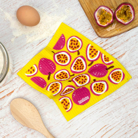 Compostable sponge cloth with a passionfruit design on a bench.