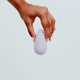 Hand holding Viola Green Eros Palm Vibrator in Lilac colour, a small, palm-sized vibrator. Powerful vibrations, effortlessly controlled with a single button. Its grip-friendly design ensures a comfortable and pleasurable experience. Its discreet size also makes it the perfect travel buddy. It's crafted from sustainable materials, such as super silky body-safe silicone and is designed to combine sophistication with eco-consciousness, making it the perfect companion for sustainable pleasure seekers.