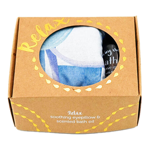 Cardboard gift box containing a blue, lavender scented eye pillow and a rose quartz bath oil.